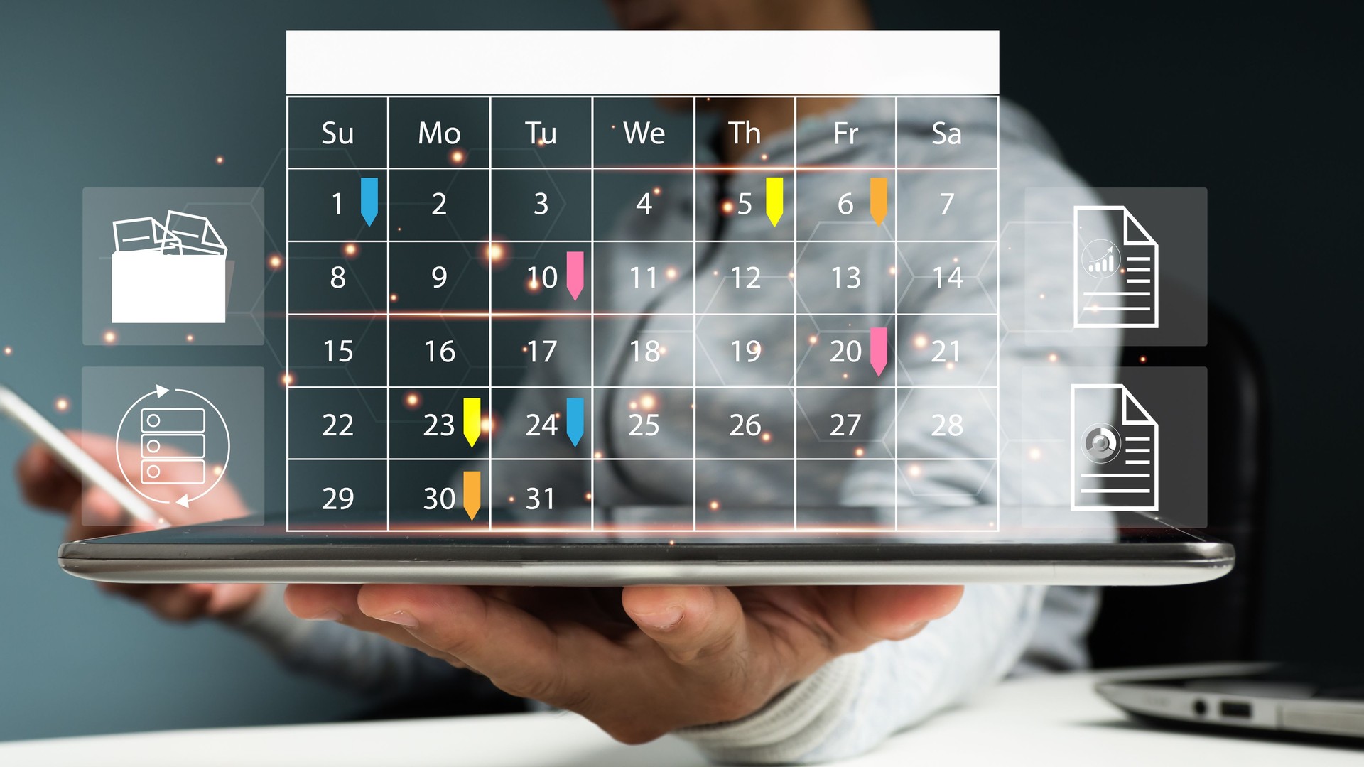 Event planners use timetables and agendas to arrange and schedule events. On the office table, a businessman is using his mobile phone and taking notes on the calendar desk.